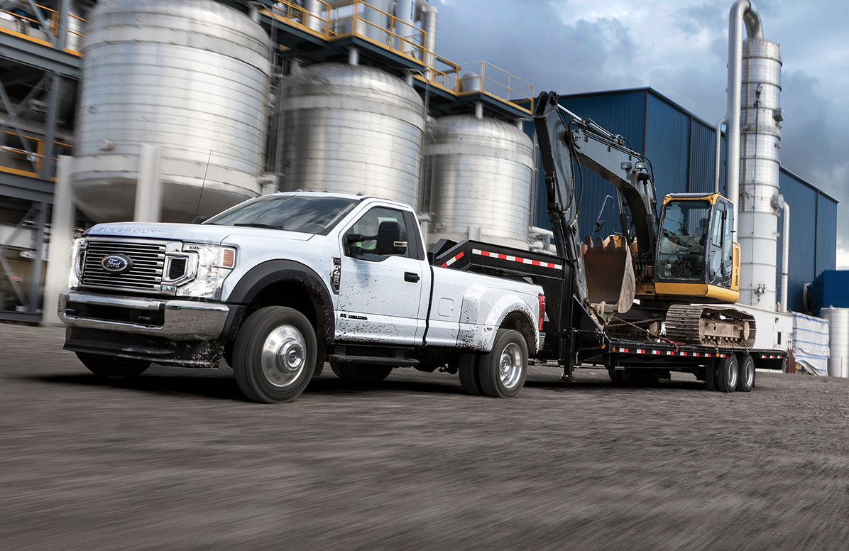 A Ford Super Duty truck driving to a pick up a load.